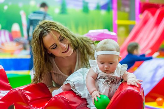 mother and child play in the children's room