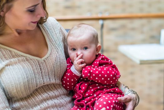 happy mother with a baby in her arms in the room