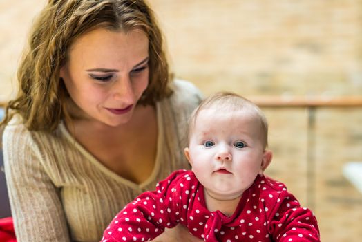 happy mother with a baby in her arms in the room