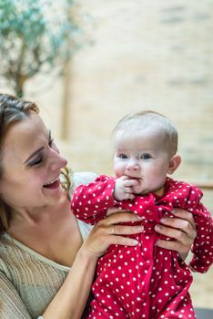 happy mother with a baby in her arms in the room