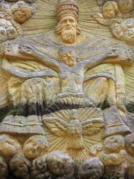 Relief of the Holy Trinity - stone altar carved in sandstone cliff in the forest from 1740 - old stone altar carved in sandstone cliff in the forest near the village Marenicky, Lusatian Mountains, Czech Republic.
