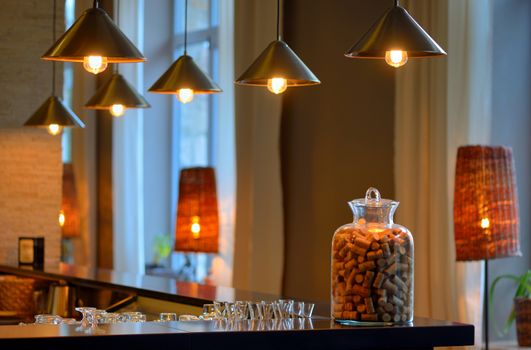 various old wine bottle corks in a glass vase at bar