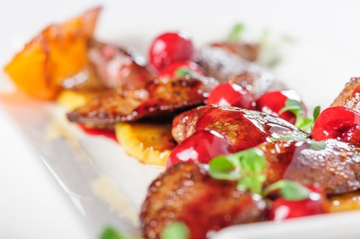 Grilled chicken's liver with chery tomato and other vegetables. Selective focus.