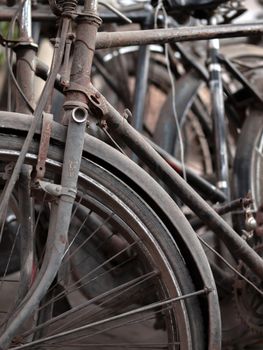 COLOR PHOTO OF ABSTRACT SHOT OF OLD RUSTY BICYCLE PARTS