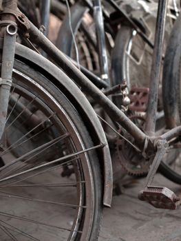 COLOR PHOTO OF ABSTRACT SHOT OF OLD RUSTY BICYCLE PARTS