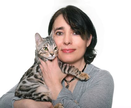 bengal kitten and woman in front of white background