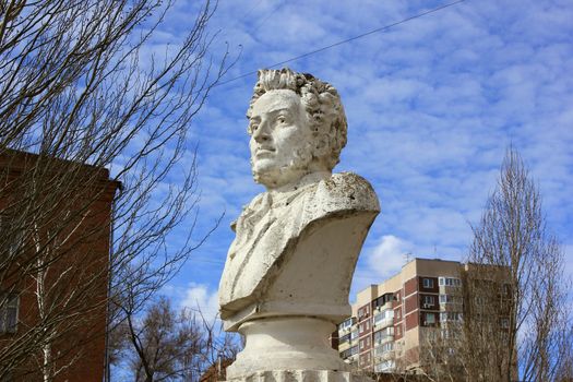 Bust of the Russian poet Pushkin in the yard at the building of high school in the city of Volgograd