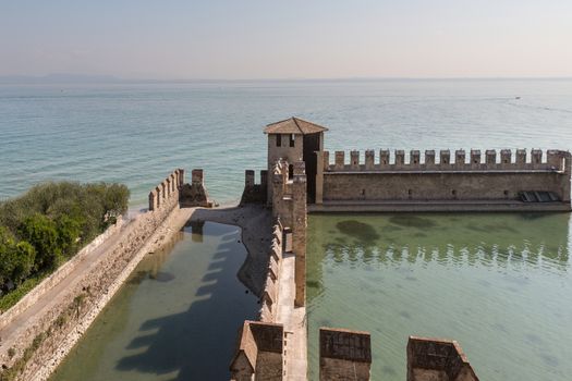 The fortress walls of Castello Scaligero in Sirmione on Lake Garda in Italy