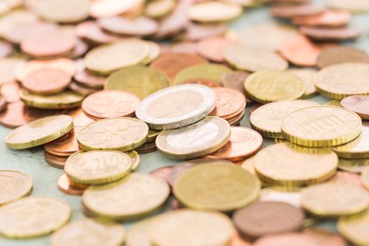 Heap of assorted Euro coins in different denominations in a vertical shallow dof view in a full frame financial background