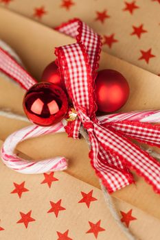 Close-up composition of Christmas present boxes of kraft paper with ribbons, decorations and stars pattern