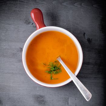 Pumpkin creme soup on a wooden surface