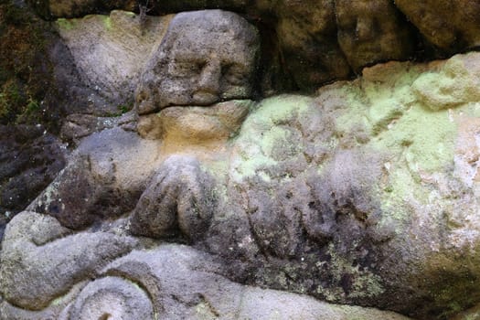 Stone altar carved into the sandstone - detail of the head of a praying angel.
Stone altar carved in sandstone cliff in the forest near the village Marenicky, Lusatian Mountains, Czech Republic.
