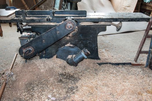 Old and used planing machine in the joinery workshop