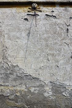 Old sundial on the wall of Baroque chapel