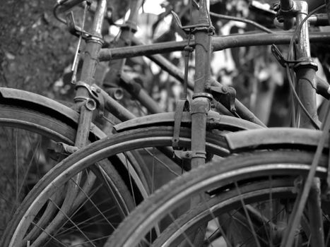 BLACK AND WHITE PHOTO OF ABSTRACT SHOT OF OLD RUSTY BICYCLE PARTS