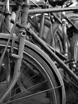 BLACK AND WHITE PHOTO OF ABSTRACT SHOT OF OLD RUSTY BICYCLE PARTS