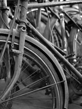 BLACK AND WHITE PHOTO OF ABSTRACT SHOT OF OLD RUSTY BICYCLE PARTS