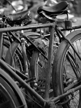 BLACK AND WHITE PHOTO OF ABSTRACT SHOT OF OLD RUSTY BICYCLE PARTS