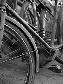 BLACK AND WHITE PHOTO OF ABSTRACT SHOT OF OLD RUSTY BICYCLE PARTS