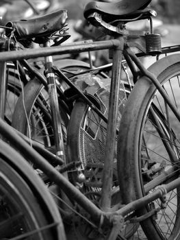 BLACK AND WHITE PHOTO OF ABSTRACT SHOT OF OLD RUSTY BICYCLE PARTS