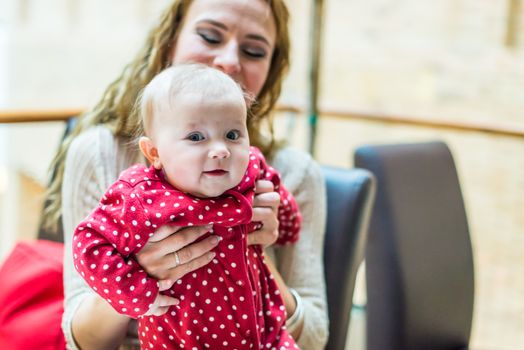 happy mother with a baby in her arms in the room