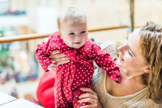 happy mother with a baby in her arms in the room