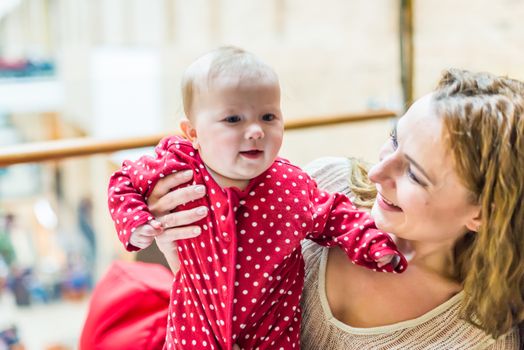 happy mother with a baby in her arms in the room