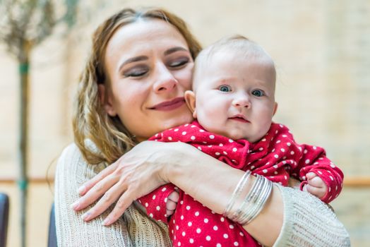 happy mother with a baby in her arms in the room