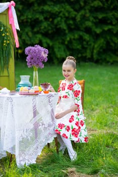 beautiful girl has breakfast in the Green Garden