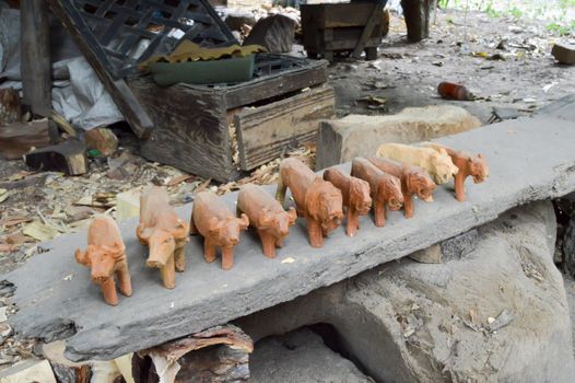 Several rough wooden sculpture of wild animals in a cooperative in Kenya
