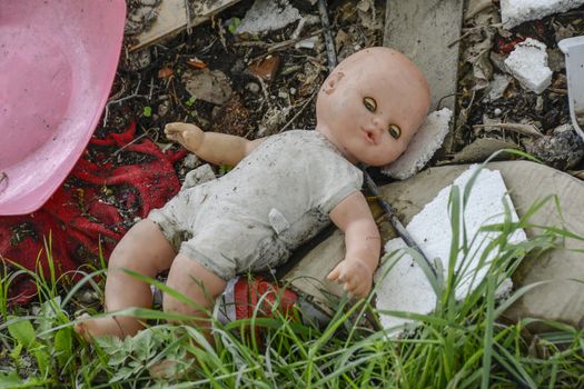 toy doll is completely left alone among the rubbish