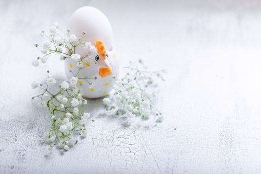 Egg with Gypsophila on a white background. Easter Symbols.