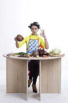 Housewife is preparing in the kitchen on a white background