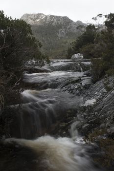 Lake Lilla in Cradle Mountain, Tasmania on a snowy and overcast day.