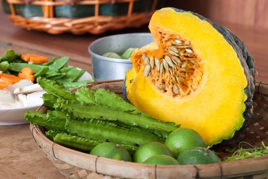 Princess bean (Psophocarpus tetragonolobus) and pumpkin and vegetable split In bamboo basket for cooking