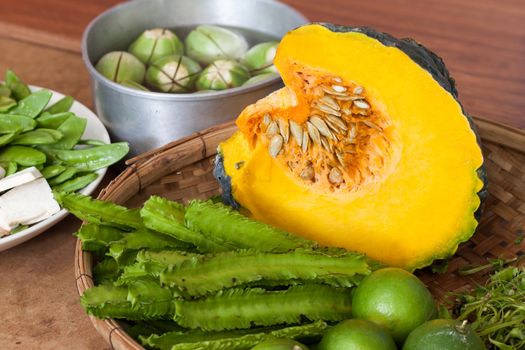 Princess bean (Psophocarpus tetragonolobus) and pumpkin  and vegetable split In bamboo basket for cooking