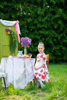 beautiful girl has breakfast in the Green Garden