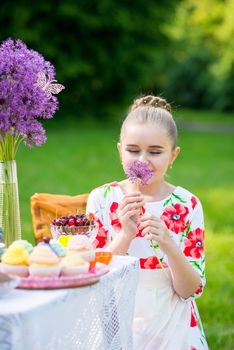 beautiful girl has breakfast in the Green Garden