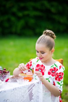 beautiful girl has breakfast in the Green Garden