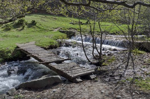 Small wooden bridge in mountain river in Vitosha mountain, Sofia