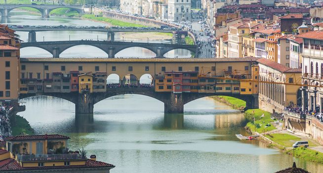 Ponte Vecchio in Florence with Tourists in a sunny day