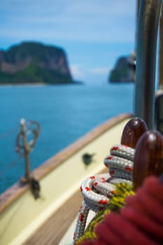 view of cliffs in thailand of the front of a sailing boat