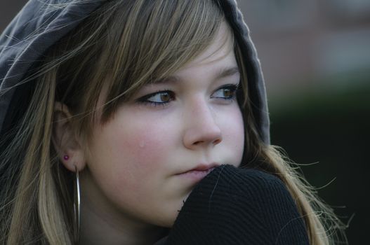 crying girl looks straight ahead and thinking