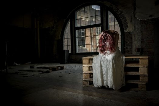 young bride sitting with her hands in her hair before the wedding