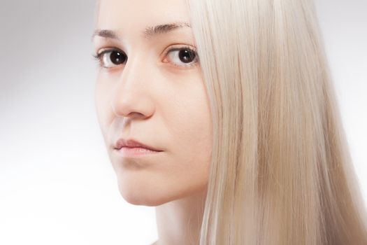 Studio portrait of beautiful caucasian girl with blond hair