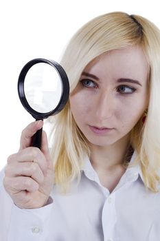 Portrait of beautiful young woman with magnifier glass