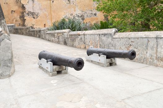 Old cast iron guns in front of the entrance to the Mombasa fortress in Kenya