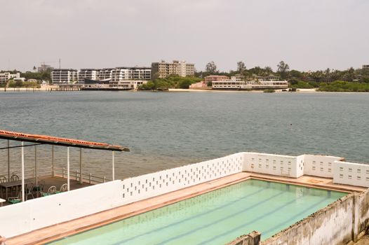 Private pool on the Mombasa River in Kenya with a restaurant in the background