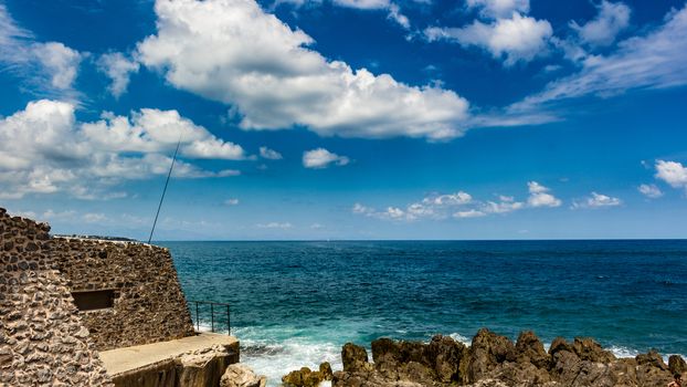 The sea with the stone wall. Copy space.