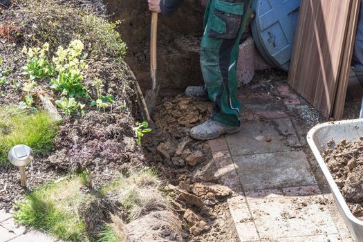 Gardening, loaded a wheelbarrow with earth excavation